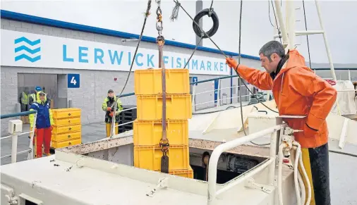  ??  ?? LANDMARK: Lerwick Fishmarket receives its first whitefish landings from local vessel Sedulous LK 308, overseen by skipper John Wishart