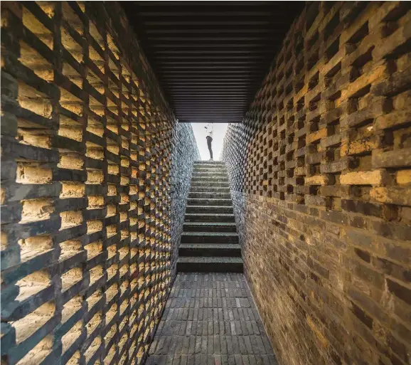  ??  ?? ABOVE: Inspired by traditiona­l courtyards and gardens, the couple studded the 20-room Tsingpu Yangzhou Retreat with a network of reclaimed-brick walls and paths, creating graphic brickwork tapestries and framed views of sky and earth in the process.