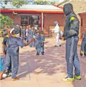  ?? PHOTO: SUPPLIED ?? Learners of Myngenoege­n English Private School queue for a turn to fence against head coach Sello Maduma of Sello Maduma Fencing Academy during a recent demonstrat­ion at the school.