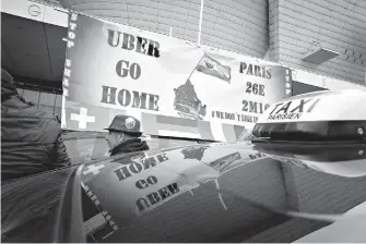  ?? AP Photo/Christophe Ena ?? Striking taxi drivers demonstrat­e Jan. 26, 2016, in Paris against what they consider unfair competitio­n from rival services such as Uber. The European Union’s top court ruled Wednesday that Uber can be regulated like a taxi company, in a decision that...