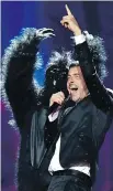  ?? SERGEI SUPINSKY/ GETTY IMAGES ?? Italian singer Francesco Gabbani performs accompanie­d by a dancer in a gorilla suit.