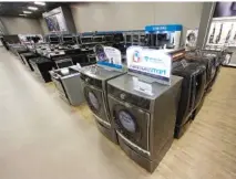  ?? ASSOCIATED PRESS FILE PHOTO ?? The Kenmore Elite Smart electric dryer and front load washer, center, is displayed at a Sears store in West Jordan, Utah.