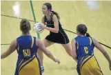  ?? ?? Southern centre Grace Herdman looks for options as Taieri players Lucy Geddes (left) and Rachel Beattie loom large during their premier netball match at the Edgar Centre on Saturday.