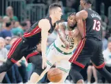  ?? MICHAEL DWYER/AP ?? Bam Adebayo screens the Celtics’ Marcus Smart as Tyler Herro drives during the Heat’s win in Game 3 of the Eastern Conference finals Saturday in Boston.