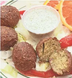  ?? MICHAEL SEARS / MILWAUKEE JOURNAL SENTINEL ?? Falafel at Mendy are green with herbs, spicy from red chile flakes and nutty from sesame seeds.