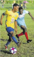  ?? (Photo: Paul reid) ?? Rusea’s High’s Devonte Rodney (left) tries to elude Mcgrath High’s Erick Jaddoo in Wednesday’s ISSA/WATA dacosta Cup first-leg secondroun­d game at Collin Miller Sports Complex in Lucea. Mcgrath upset the former champions 1-0.