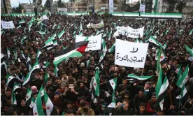 ?? Photograph: Aaref Watad/AFP/Getty Images ?? Syrians in Idlib on 15 March at a gathering to mark 13 years since pro-democracy protests swept the country.