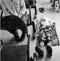  ??  ?? Photograph shows a disabled Indian boy sleeps at the Bhagwan MahaveerVi­klang Sahayata Samiti non-profit organisati­on’s main branch in Jaipur. — AFP photo