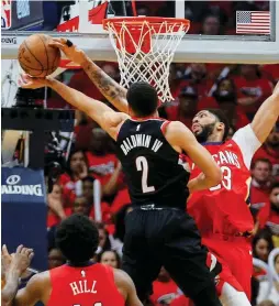  ?? (Reuters) ?? NEW ORLEANS PELICANS forward Anthony Davis (right) blocks a shot by Portland Trail Blazers guard Wade Baldwin during the the Pelicans’ 131-123 home victory over the Blazers on Saturday night to seal a 4-0 sweep of the Western Conference first-round...