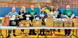  ?? Photo by Andy Mckowan ?? Volunteers and staff from the Kane Area Community Center along with Simon of Cyrene Trucking prepared 100 boxes filled with local food for those in need Thursday May 9. From left; Michelle Palmer, Executive Director for the Kane Area Community Center; Ashley Parik, volunteer; Deacon Dave Galvin of St. James the Greater Catholic Church and Simon of Cyrene Trucking; Linda Eschrich, Assistant Director for the Kane Area Community Center; Cody Eschrich, volunteer; Brenda Bobich, volunteer; C.J. Bingaman, volunteer; and Mike Azar from St. James the Greater Catholic Church and Simon of Cyrene trucking. Not pictured are Tiffany Swanson, volunteer and Denver Brown, custodian at the Community Center; who also helped with the food giveaway.