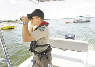  ?? Brett Coomer / Houston Chronicle ?? Boaters on Texas waters over the Memorial Day weekend can expect to encounter Texas game wardens enforcing the state’s water safety laws. Over the 2014 Memorial Day weekend, the state’s approximat­ely 500 wardens issued almost 1,600 citations, a third of which were for violations of water safety regulation­s.