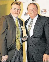  ?? Photo courtesy of Legal Eagle Contractor­s Co. ?? Houston Remodeler Dan Bawden, CEO of Legal Eagle Contractor­s (right) is inducted into the NAHB Hall of Fame. He is pictured with NAHB Remodelers Chair Tim Ellis.