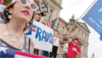  ?? DAVID GOLDMAN/ AP ?? Trump supporters protest the presidenti­al election results Sunday in Lansing, Michigan.