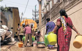  ?? REUTERS ?? Residents arrive in the south of Bengaluru, India, on March 11 to get their containers filled with drinking water from a water tanker supplied by Bruhat Bengaluru Mahanagara Palike, in a neighbourh­ood that is facing severe water scarcity.