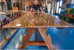  ?? Associated Press ?? Wood worker Walter Hansen displays a table Feb. 16, 2016, that he created using wood from the now demolished Fort Crockett site in League City, Texas.