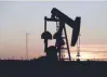  ?? — Reuters ?? A pump jack operates at sunset in an oil field in Midland, US.