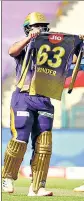  ?? BCCI ?? Nitish Rana holds a KKR shirt with his late father-in-law’s name on it after a fifty.