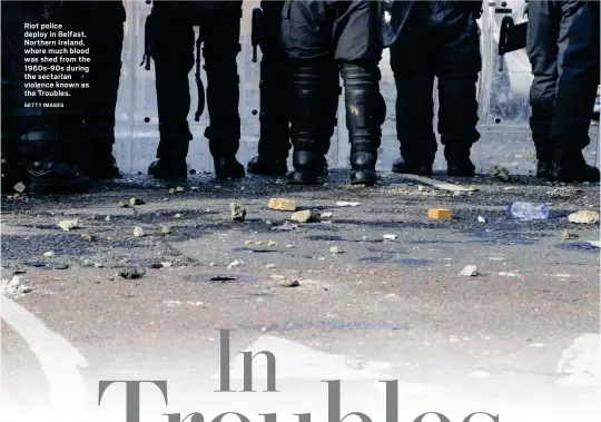  ?? GETTY IMAGES ?? Riot police deploy in Belfast, Northern Ireland, where much blood was shed from the 1960s-90s during the sectarian violence known as the Troubles.