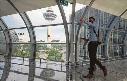  ?? EPA PIC ?? A man walking along a corridor in Singapore’s Changi Airport last week.