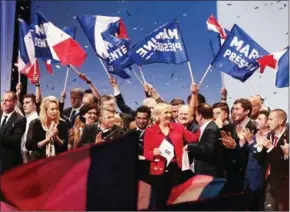  ?? JOEL SAGET/AFP ?? French presidenti­al election candidate for the far-right National Front party Marine Le Pen (centre) attends a campaign meeting in Paris on Monday.