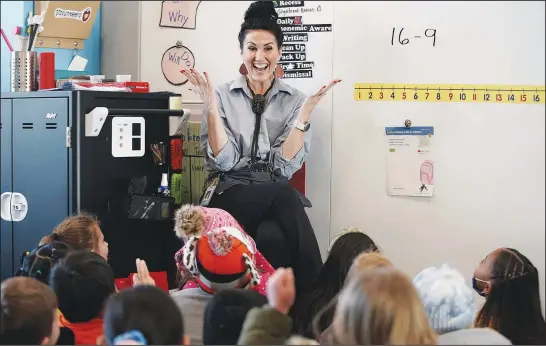  ?? (AP/Deseret News/Jeffrey D. Allred) ?? Tiffany Hatch, a first grade instructor, teaches math to her class Dec. 15 at South Clearfield Elementary in Clearfield, Utah. Hatch earned her teaching degree through Weber State University’s teacher assistant pathway to teaching.