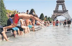  ?? PHOTO: ZAKARAIA ABDELFAFI ?? Cooling down: A boy jumps into the water of the Trocadero Fountain in Paris yesterday amid the heatwave.