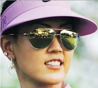  ?? D A N N Y J O H NS T O N / T H E A S S O C I AT E D P R E S S ?? Golfer Michelle Wie protects her eyes during an LPGA event.