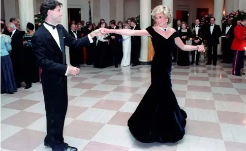  ??  ?? ABOVE: Diana shone in a deep blue velvet Victor Edelstein gown as she danced with John Travolta at a White House Gala Dinner in 1985. OPPOSITE: The Princess in a photograph by her reportedly favourite snapper, Patrick Demarcheli­er, taken in 1990.