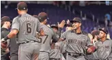  ?? JASEN VINLOVE/USA TODAY NETWORK ?? The Diamondbac­ks celebrate Thursday’s 4-0 victory in Miami, the team’s eighth win on a 10-game road trip. They return to Chase Field tonight to host the San Francisco Giants.