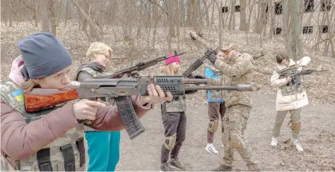  ?? — AFP file photo ?? Ukrainian civilian women practice with weapons as they attend training for women focused on the use of weapons and combat medical kit, in Kyiv.