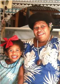  ??  ?? Cake and smiles … Loraina Masibuli with her granddaugh­ter Mili (right); a generous wedge of the chocolate cake, cooked in the traditiona­l way (opposite page).