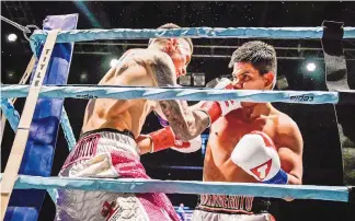  ?? ROBERTO E. ROSALES/JOURNAL ?? Albuquerqu­e’s Jason Sanchez, left, goes toe-to-toe with Rafael Reyes during the fourth round of their bout Friday night at the Santa Ana Events Center. Sanchez won after Reyes could not continue due to injury.