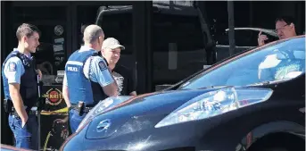  ?? PHOTO: CRAIG BAXTER ?? At the scene . . . Police interview the alleged victim (left) and a witness in the Repco car park in Dunedin yesterday morning following an alleged roadrage incident.