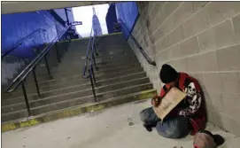  ?? MARK LENNIHAN, FILE - THE ASSOCIATED PRESS ?? In this 2015 file photo, a homeless man holds a sign asking for money.