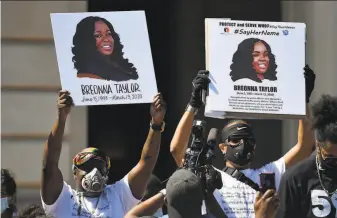  ?? Timothy D. Easley / Associated Press ?? Protesters demand justice in the death of Breonna Taylor, who was killed in her apartment by police in Louisville, Ky. Only one of the three officers who opened fire has lost his job.