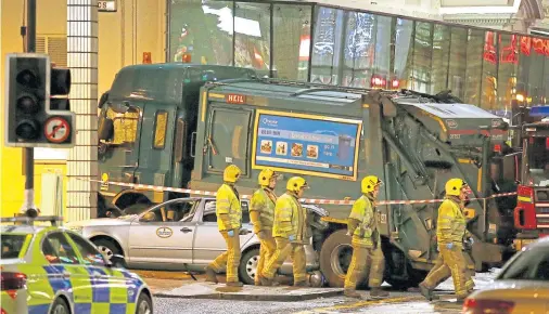  ??  ?? AFTERMATH: Fire crews at the scene of the catastroph­ic Glasgow bin lorry crash, which happened on December 22 2014