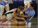  ?? JULIA MALAKIE — LOWELL SUN ?? Foxboro’s Erin Foley, left, hits the floor to battle for a loose ball with Dracut’s Brodie Gannon. Foxboro won the Division 2 girls basketball state title, 73-53.