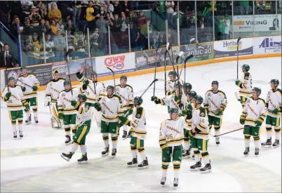  ?? The Canadian Press ?? Humboldt Broncos players salute the crowd after their SJHL game against the Nipawin Hawks in Humbolt, Sask., on Wednesday night. The Broncos played their first game since a bus crash claimed 16 lives in April, dropping a 2-1 decision.