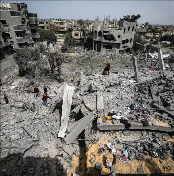  ?? Picture: AP Photo/Ismael Abu Dayyah ?? Above, Palestinia­ns inspect the damage to a residentia­l building after an Israeli air strike in the Maghazi refugee camp, central Gaza, on Friday