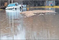  ?? [BRENDAN SULLIVAN/ OMAHA WORLDHERAL­D VIA THE ASSOCIATED PRESS] ?? A vehicle is stuck in floodwater­s Tuesday in Fremont, Neb.