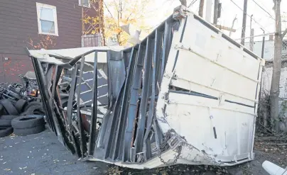  ?? NICOLAUS CZARNECKI / BOSTON HERALD ?? WHOOPS: The heavily damaged container, above, involved in the early morning crash, below, in the Thomas P. O'Neill Jr. Tunnel is seen at the Todisco Tow lot yesterday.