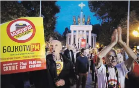  ?? THANASSIS STAVRAKIS THE ASSOCIATED PRESS ?? Protesters who had urged voters to boycott Sunday’s referendum to change Macedonia’s name to North Macedonia chant slogans as they demonstrat­e in Skopje.