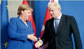  ?? AP ?? Germany’s Chancellor Angela Merkel and British Prime Minister Boris Johnson end a joint press conference in Berlin.