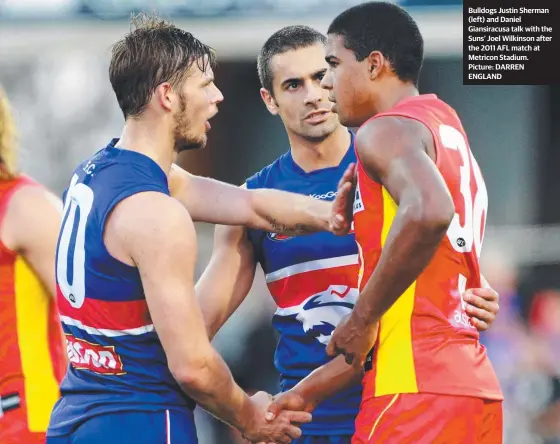  ?? Picture: DARREN ENGLAND ?? Bulldogs Justin Sherman (left) and Daniel Giansiracu­sa talk with the Suns’ Joel Wilkinson after the 2011 AFL match at Metricon Stadium.