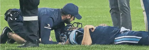  ?? COLE BURSTON/THE CANADIAN PRESS ?? Argonauts QB Ricky Ray gets medical attention after a hit in the third quarter of Saturday night’s home opener. Ray left on a stretcher and was taken to hospital.