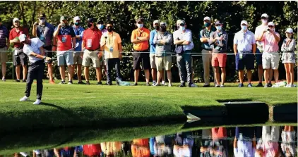  ?? GETTY IMAGES ?? For my next trick: McIlroy skims a shot across the pond on the 16th in practice yesterday