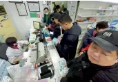  ?? — AP ?? People line up to buy face masks at a pharmacy in Hangzhou in eastern China’s Zhejiang Province on Thursday.