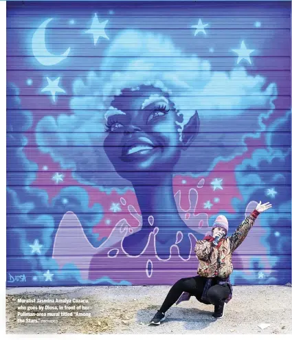  ?? PROVIDED ?? Muralist Jasmina Amalya Cazacu, who goes by Diosa, in front of her Pullman-area mural titled “Among the Stars.”