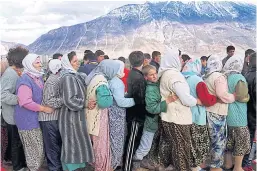  ??  ?? INNOCENCE LOST: Petrit Halilaj, centre, in green coat, an 11-year-old refugee during the war. Today, Halilaj is an accomplish­ed artist