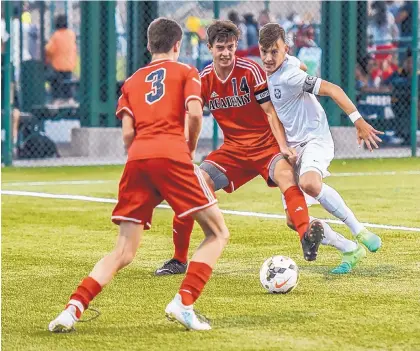  ?? NICK FOJUD/FOR THE JOURNAL ?? Albuquerqu­e Academy’s Owen Keleher (14) and La Cueva’s Joseph Keller, right, vie for the ball during Friday night’s boys championsh­ip game in the Albuquerqu­e Metro Soccer Championsh­ips at the APS Soccer Complex.